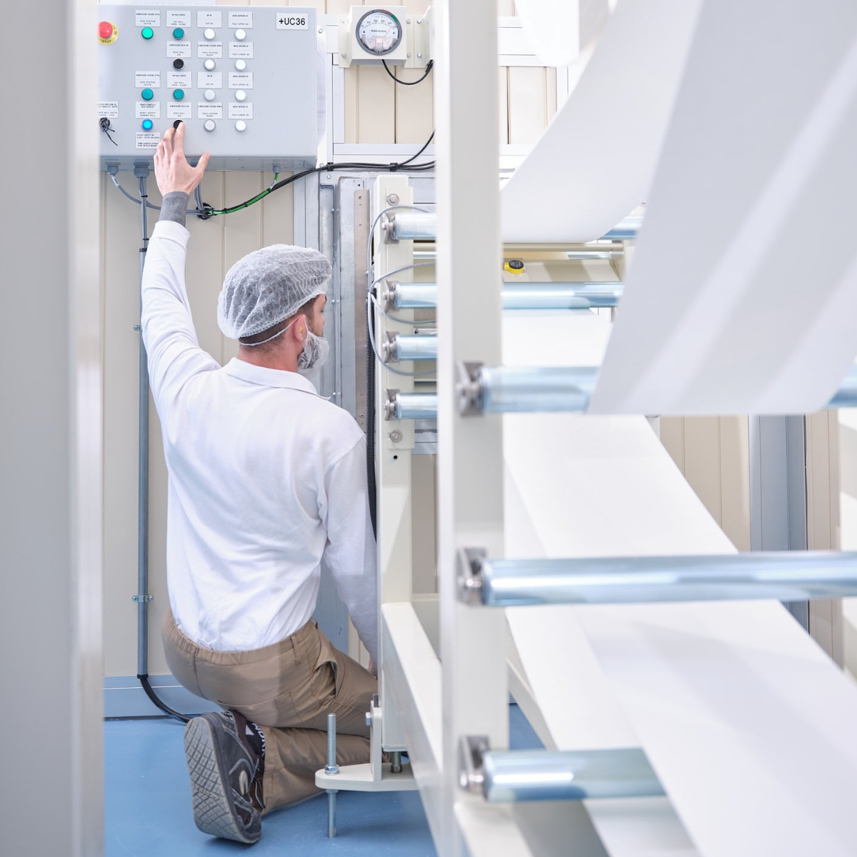 Operator monitoring absorbent materials production process to ensure quality and supply continuity